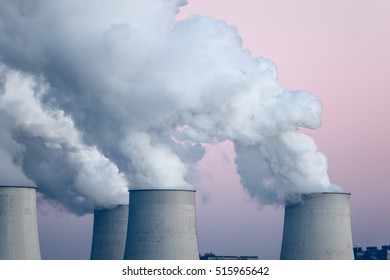 Smoking pipes of thermal power plant on sunset