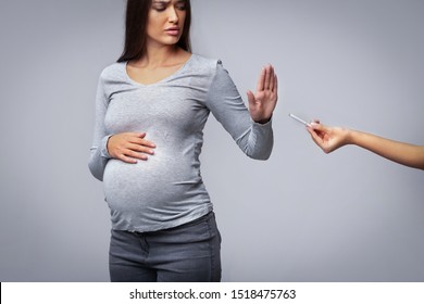 Smoking And Pregnancy. Pregnant Girl Refusing To Take Cigarette Gesturing Stop Over Gray Studio Background.