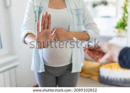 Smoking And Pregnancy. Pregnant Girl Refusing To Take Cigarette Gesturing Stop. pregnant woman with belly refuses passive Smoking. The concept of the rejection of bad habits
