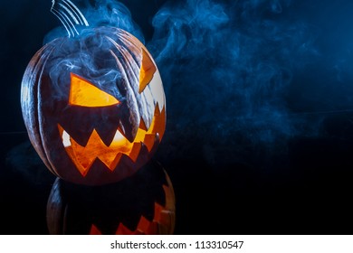 Smoking scary halloween pumpkin head