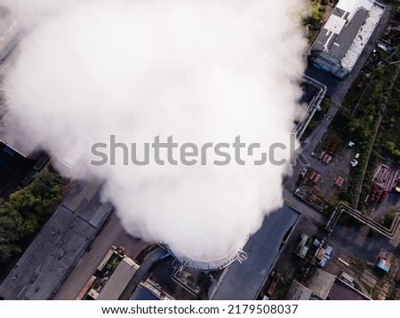 Smoky chimneys of the power plant aerial view.Electric power generation,power plant for burning coal.Thick smoke from fuel.Atmospheric pollution,harmful emissions and global warming,ecological problem