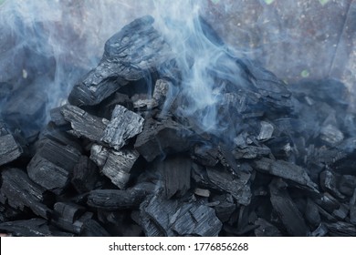 Smoky Embers From An Extinguished Fire. Burned Boards Smoke After A Fire