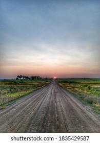 Smoky Evening With Sun Setting On Reservation Dirt Road. 