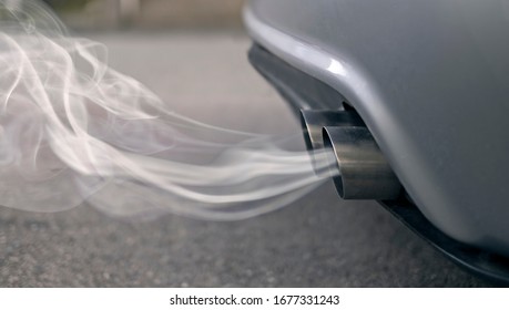 Smoky exhaust pipes from a starting diesel car.