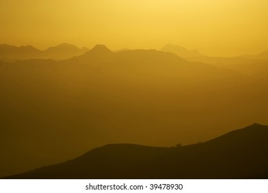 Smoky Gold Gradiant At Mountain Sunset