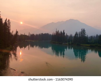 Smoky sunset over the river after wildfires in Banff, Alberta, Canada 