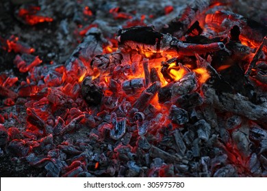 Smoldering ashes of a bonfire.