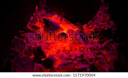 Smoldering charcol in a fire