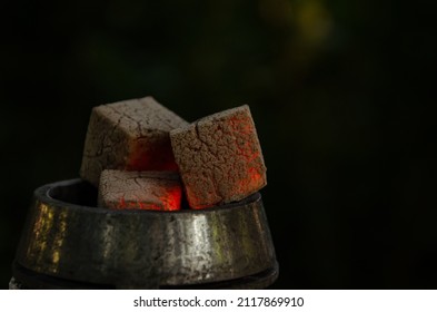 Smoldering embers in kaloud on hookah. Hookah smoking concept. Kalaud, charcoal tongs on hookah plate stands in nature. - Powered by Shutterstock - Get 15% off with code: PIKWIZARD15
