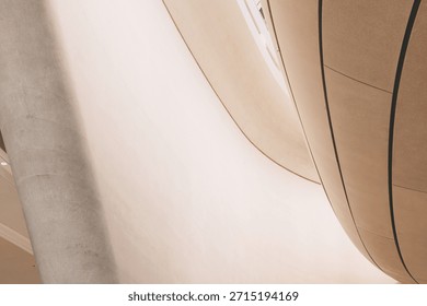 Smooth architectural forms creating an abstract pattern with concrete curves and a column, emphasizing modern design and minimalism