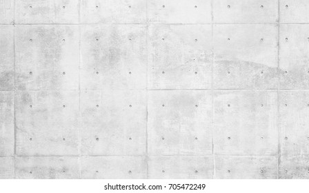 Smooth Bare Concrete Wall With Many Concrete Form Dimples And Grid Lines.