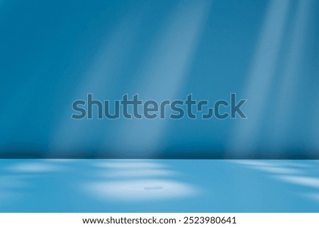 Smooth, blurred blue background with empty table and abstract light reflections and shadows on wall. Stylish holiday mock up for winter presentation, branding products, cosmetics and food.