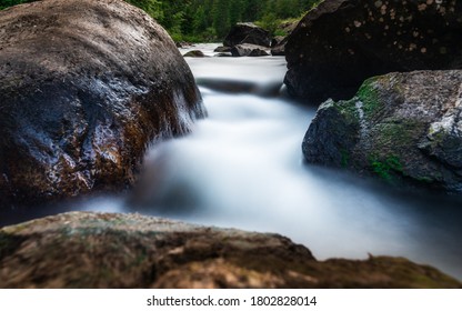 Smooth Creek Water Flowing  Between The Rocky Canyon In Idaho Panhandle National Forest.