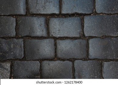 Smooth Dark Brick Road In Ancient European City. Closeup View From Above.