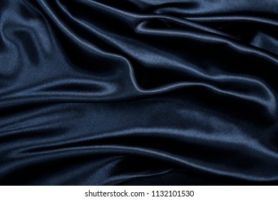 Smooth elegant black silk or satin texture can use as abstract background. Luxurious background design