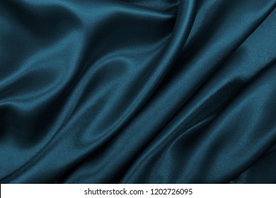 Smooth elegant dark grey silk or satin texture can use as abstract background. Luxurious background design