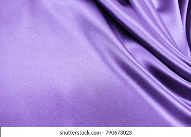 Smooth elegant purple violet color silk or satin luxury cloth fabric texture, abstract background design.