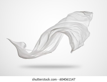 Smooth elegant transparent white cloth separated on gray background. Texture of flying fabric.