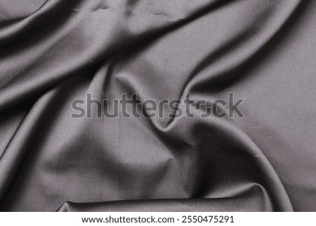 Smooth elegant wavy deep black silk cloth fabric material texture. Background for banner, backdrop or texture for 3D mapping. Satin luxury cloth texture can use as abstract background