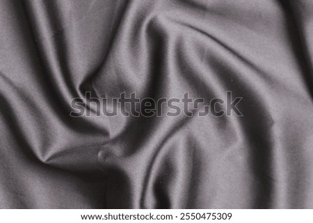 Smooth elegant wavy deep black silk cloth fabric material texture. Background for banner, backdrop or texture for 3D mapping. Satin luxury cloth texture can use as abstract background