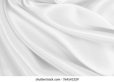 Smooth elegant white silk or satin luxury cloth texture can use as wedding background. Luxurious Christmas background or New Year background design