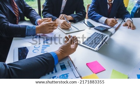 Smooth Focus , group of business venture capitalists are studying the market and planning their investments to get the best return for them and listening to advice from an investment advisor.