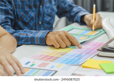 Smooth Focus, group of web designers are working together to develop mobile responsive website with UI UX Front End Designer Previewing. website designers in form of mobile applications with UI UX - Powered by Shutterstock