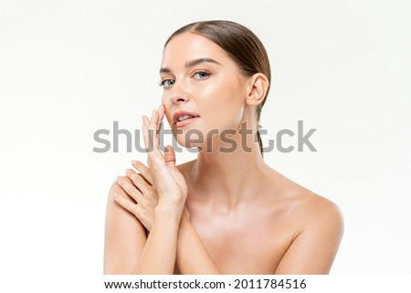 Smooth fresh glowing skin woman touching her face in white isolated studio background for beauty and skincare concepts
