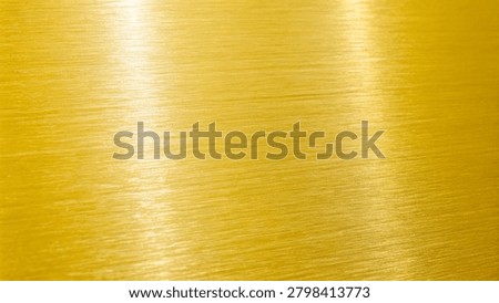 Smooth golden metallic surface with subtle linear reflections and texture