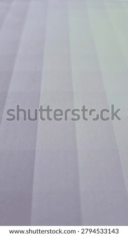 A smooth gradient background transitions from light to dark purple. The image features parallel, horizontal stripes, creating a sequential pattern. The texture appears soft, possibly resembling fabric or a digital rendering with a subtle sheen. The colors blend seamlessly, with each stripe gradually shifting in shade, contributing to a harmonious visual effect.
