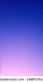 Smooth gradient from blue to pink through purple. Neon sky at sunset. Ultramarine and pale pink horizontal background