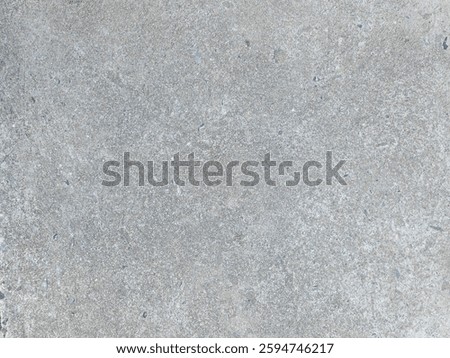 A smooth gray concrete surface featuring subtle texture ideal for backgrounds, design elements, and construction projects. Perfect for various applications.