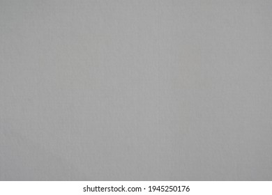 Smooth homogeneous fibrous surface, rough texture of paper, gray color.