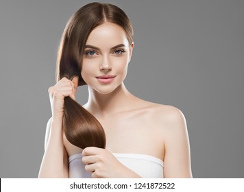 Smooth long brunette hair woman healthy and strong with healthy clean skin  female over gray background - Shutterstock ID 1241872522