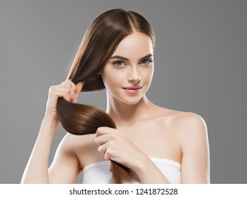 Smooth long brunette hair woman healthy and strong with healthy clean skin  female over gray background - Shutterstock ID 1241872528
