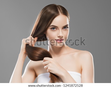 Smooth long brunette hair woman healthy and strong with healthy clean skin  female over gray background