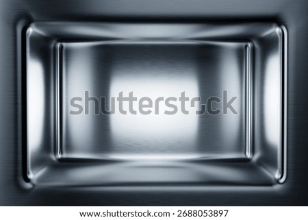 Smooth metal interior with a subtle gradient center.