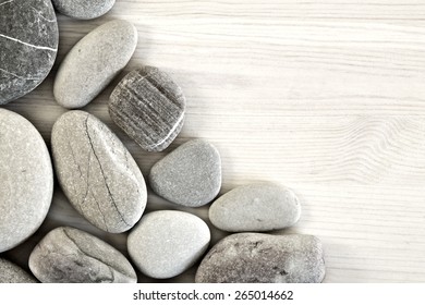 Smooth pebbles on an old wooden background. Place for your text
