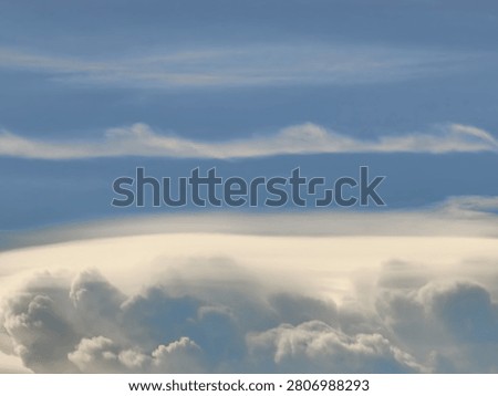 Smooth Pileus Cloud Cap Forming Above a Cumulus Tower