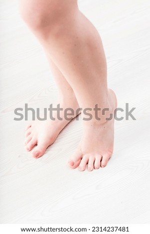 Smooth, polished feet on wooden floor. Attractive feminine care and beauty