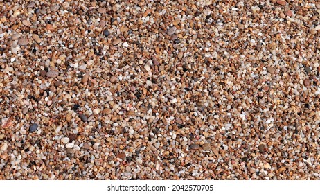 Smooth and polished. Pebble view from above. Colorful small pebbles with a stone texture. Gravel pebbles or fragments of rocks. Weathering and erosion of rocks.  - Powered by Shutterstock