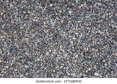 Smooth round pebbles texture background. Pebble sea beach close-up, dark wet pebble and gray dry pebble - Shutterstock ID 1971680945