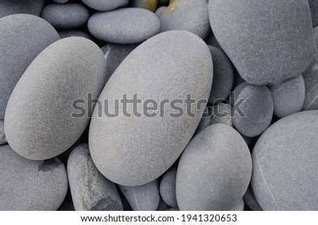 Smooth round pebbles texture background. Pebble sea beach close-up

