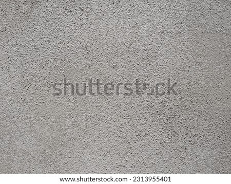 Smooth sandy cement parging material texture example. Parging is a technique used to apply a thin coat of cement-based mortar over the surface of a wall or structure. Visible fine sand grains.