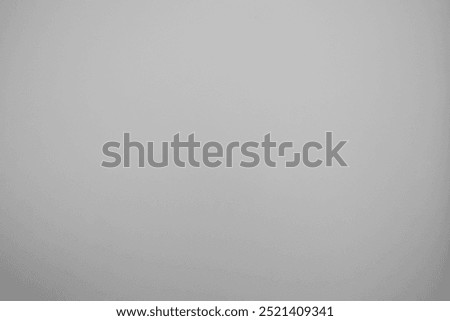 Smooth wall background texture. Light vignette on a solid grey colored mural, wall for product display, presentation background, flyer, invite card, graphic design. Gray, light grey wallpaper backdrop