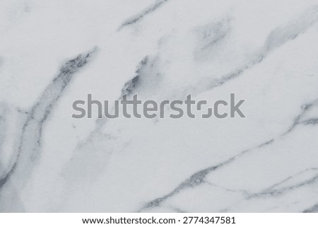 Smooth white marble surface with subtle gray veining for elegant background design