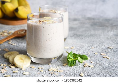 Smoothie With Banana And Oatmeal For Breakfast On A Light Concrete Background. Detox Menu.