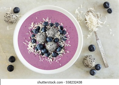 Smoothie Bowl With Blueberries, Dragon Fruit And Coconut, Overhead Scene On Marble