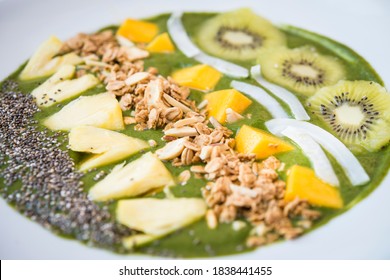 Smoothie Bowl With Kiwi, Coconut, Mango, Pinapple, Granola And Chia Seeds With Green Yogurt