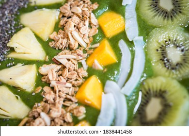 Smoothie Bowl With Kiwi, Coconut, Mango, Pinapple, Granola And Chia Seeds With Green Yogurt